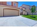A well-maintained two-story house with a terracotta roof and a spacious driveway leading to the two-car garage at 1663 Cloister Ave, Henderson, NV 89014