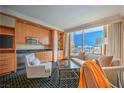 Bright living room with modern furniture, kitchenette, and expansive city views at 2000 Fashion Show Dr # 4105, Las Vegas, NV 89109