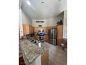 Kitchen with stainless steel appliances, granite countertops, and light wood cabinets at 3975 N Hualapai Way # 246, Las Vegas, NV 89129