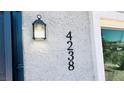 Close-up of house number and exterior light fixture showing well-maintained facade at 4238 Boratko St, Las Vegas, NV 89115