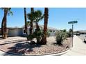 Street corner view of a well-kept single Gathering home with desert landscaping at 4238 Boratko St, Las Vegas, NV 89115