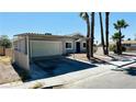 View of single-story home with covered parking, desert landscaping, and palm trees at 4238 Boratko St, Las Vegas, NV 89115