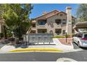 The exterior of this condo features a tile roof, stucco, mailbox and covered parking at 5415 W Harmon Ave # 2075, Las Vegas, NV 89103