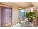Welcoming front porch with seating area and lush greenery, perfect for relaxing outdoors at 5917 Horsehair Blanket Dr, North Las Vegas, NV 89081