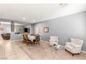 Bright living room featuring plush seating, neutral tones, and an adjacent dining space at 5917 Horsehair Blanket Dr, North Las Vegas, NV 89081