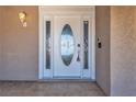 Elegant white front door featuring glass paneling with decorative design and an outdoor light fixture at 6628 Celeste Ave, Las Vegas, NV 89107