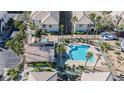 Aerial view showcasing community pools, lush landscaping, and well-maintained apartment buildings with ample parking at 6808 Indian Chief Dr # 204, Las Vegas, NV 89130