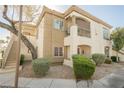 Inviting two-story condo with a private balcony, attractive landscaping, and staircase for easy access at 6808 Indian Chief Dr # 204, Las Vegas, NV 89130
