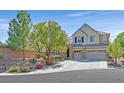 Charming two-story home featuring a three-car garage and a beautifully landscaped front yard with mature trees at 7033 Twin Forks Peak St, Las Vegas, NV 89166