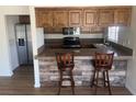 Updated kitchen with stainless steel appliances, wood cabinets, and breakfast bar at 761 Bourbon St # 5, Pahrump, NV 89048