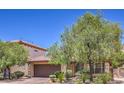 Beautiful one-story home with lush trees, desert landscaping, and a two-car garage in a desirable neighborhood at 7998 Base Camp Ave, Las Vegas, NV 89178