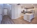 Modern kitchen with white cabinets, stainless steel appliances, and a large center island at 8026 Sunset Creek St, Las Vegas, NV 89113