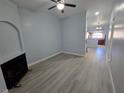 Spacious living room with wood-look flooring, fireplace, ceiling fan, and light blue walls at 8455 W Sahara Ave # 258, Las Vegas, NV 89117