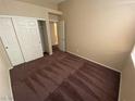 Bedroom featuring plush carpet, closet and entry doors, and neutral colored walls at 8959 Coral Shale St, Las Vegas, NV 89123