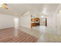 Open-concept living area showcasing wood floors and tile that leads into the kitchen area at 901 E Jaybird St, Pahrump, NV 89048