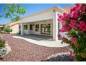Covered patio with ample space for outdoor seating and entertaining, surrounded by lush landscaping at 9704 Brawley Dr, Las Vegas, NV 89134