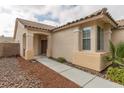 Inviting home exterior featuring a covered entryway and attractive desert landscaping at 10243 Songsparrow Ct, Las Vegas, NV 89135