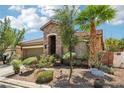 Charming single-story home featuring a stone facade, two-car garage, and drought-tolerant landscaping at 10381 Borah Park Cir, Las Vegas, NV 89178