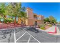 Townhome complex with desert landscaping, second-story balcony, and reserved parking at 105 Lighthouse Dr # 105, Boulder City, NV 89005