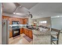 Cozy kitchen featuring granite countertops, wood cabinets, and stainless steel appliances at 105 Lighthouse Dr # 105, Boulder City, NV 89005