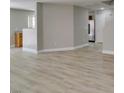 Bright, open-concept living area featuring new light wood-look flooring at 11147 Verismo St, Las Vegas, NV 89141