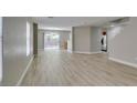 Bright, open-concept living area featuring new light wood-look flooring at 11147 Verismo St, Las Vegas, NV 89141