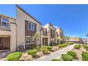 Inviting townhome exteriors with mature landscaping and charming architectural details at 1197 Mission View Ct, Henderson, NV 89002