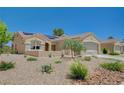 Inviting single-story home featuring desert landscaping, a two-car garage, and well-maintained curb appeal at 1466 Fieldbrook St, Henderson, NV 89052