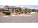 A warm-toned single story home with desert landscaping and a three-car garage at 171 Weeping Willow Ct, Pahrump, NV 89048