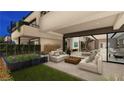 Inviting outdoor space with modern furniture, fire features, green lawn, and seamless indoor-outdoor living at 20 Lakefront Dr, Henderson, NV 89011