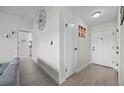 Hallway features neutral paint, wood-look floors, and decorative wall art in a brightly lit entry space at 2088 Miner Way, Las Vegas, NV 89104