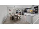 Open kitchen with stainless steel appliances, island, updated cabinets, and adjacent dining space for entertaining at 2088 Miner Way, Las Vegas, NV 89104