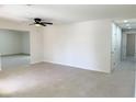 Bright and airy living room with a ceiling fan and tile flooring at 236 Pershing Dr, Las Vegas, NV 89107