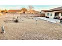 Xeriscaped backyard with patio area and block wall at 4700 E Brolio Ct, Pahrump, NV 89061