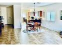 Bright open-concept living space with tile flooring, dining area and a view into the kitchen at 4700 E Brolio Ct, Pahrump, NV 89061