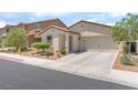Attractive home with desert landscaping and a two-car garage, presenting a neat and inviting facade at 518 Descubir Ave, North Las Vegas, NV 89081