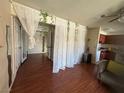 Cozy living room featuring hardwood floors, french doors, and unique sheer curtain accents at 5499 Indian River Dr # 356, Las Vegas, NV 89103