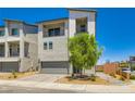 Modern two-story home with a gray color scheme, a two-car garage, and minimal landscaping at 5804 Gossamer Stone Ct, Las Vegas, NV 89141