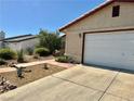 Single-story home featuring an attached 2-car garage and drought tolerant landscaping in the front yard at 6357 Cobalt Ln, Las Vegas, NV 89146