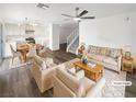 Bright and spacious living room featuring wood floors and an open floor plan to the kitchen at 6696 Merced Lake Dr, Las Vegas, NV 89156