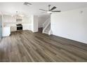 Spacious open-concept featuring wood floors, a stairway to the second floor, and an open floor plan to the kitchen at 6696 Merced Lake Dr, Las Vegas, NV 89156