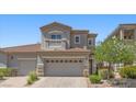 Inviting two-story home featuring a two-car garage, balcony, and well-maintained landscaping at 694 Value Ridge Ave, Henderson, NV 89012