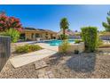 Spacious backyard featuring a swimming pool, a lounge area and desert landscaping at 7385 Severence Ln, Las Vegas, NV 89131