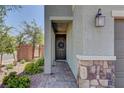Welcoming front entrance featuring stone accents and a decorative wreath on the door at 7705 Alder Forest St, Las Vegas, NV 89113