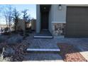 The beautiful entryway shows an attractive walkway, landscaping, and stone accents at 7705 Alder Forest St, Las Vegas, NV 89113