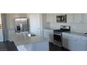 Bright kitchen with granite counters, stainless steel appliances, and white cabinets at 7705 Alder Forest St, Las Vegas, NV 89113