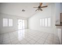 Bright living room showcasing white tiled floors, shutters, and a ceiling fan at 9728 Drumcannon Ave, Las Vegas, NV 89129