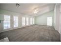 Spacious living room featuring neutral carpet, a ceiling fan, and french doors to the back at 9728 Drumcannon Ave, Las Vegas, NV 89129