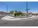 Single-story home on a corner lot with manicured landscaping and a two-car garage at 1110 Orchard Valley Dr, Las Vegas, NV 89142
