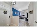 Inviting entryway leads to a cozy living room, enhanced by a stylish blue accent wall and modern decor at 1708 Anzio St, Las Vegas, NV 89108